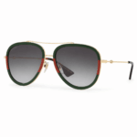 Lentes de sol Gucci estilo aviador con detalles verde y rojo, estructura dorada y cristales degradados en vista principal sobre fondo blanco.