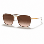 Ray-Ban RB3588 9055/13 con diseño redonda, montura dorada y lentes marrón degradado, vista angular sobre fondo blanco.